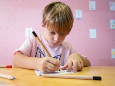 A child drawing at a table