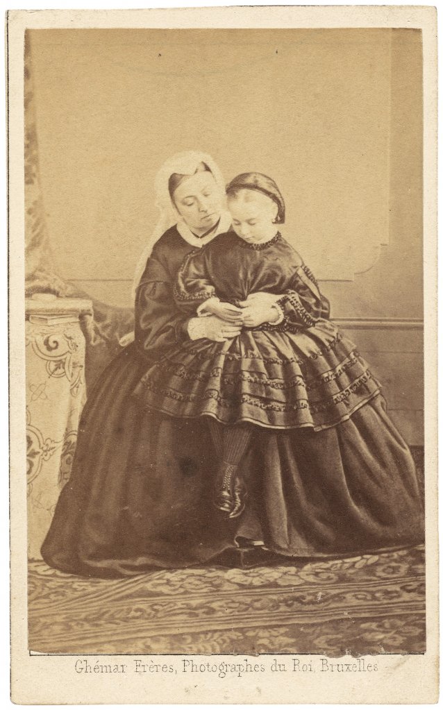 Queen Victoria and Princess Beatrice, looking at a carte de visite of Prince Albert, 1862