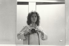 1/2 length self portrait in mirror, wearing pyjama shirt, camera at shoulder height, 1979 Carol Jerrems