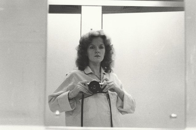 1/2 length self portrait in mirror, wearing pyjama shirt, camera at shoulder height, 1979