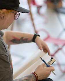 A woman with a pencil and drawing pad