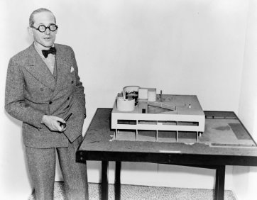 Le Corbusier with an architectural model of his Villa Savoye, which was built in Poissy, France, (1929-31) 1935