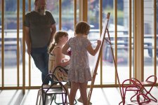 Two children drawing at an easel in the Gordon Darling Hall Two children drawing at an easel in the Gordon Darling Hall