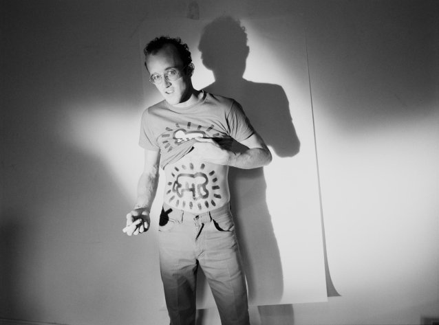American artist Keith Haring lifts his T-shirt to reveal a design he has drawn on his midriff, Australia, 1984 Polly Borland