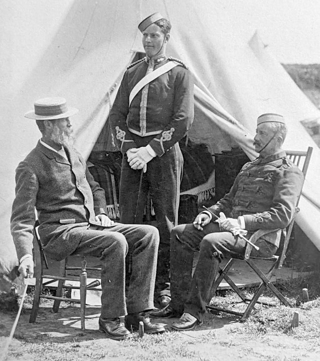William Robertson activates his camera by remote cord to capture himself, his son Jack, and a senior officer, c. 1892