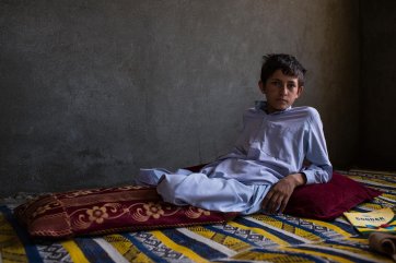 Twelve-year-old Shafiqullah from Nangarhar province lost both legs when an unexploded rocket-propelled grenade was brought home by a sibling and accidentally dropped. Four of the family were killed in the accident and seven children lost nine legs in total, 2018 Andrew Quilty