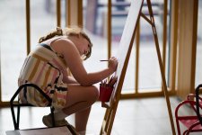 A child drawing at an easel