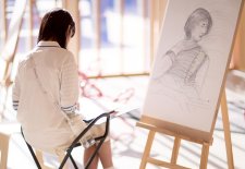 Drawing on paper at an easel in the Gordon Darling Hall Drawing on paper at an easel in the Gordon Darling Hall