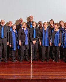 Rhythm Syndicate choir standing together on stage
