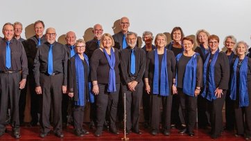 Rhythm Syndicate choir standing together on stage