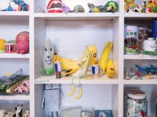 A collection of toys sitting on white shelves A collection of toys sitting on white shelves