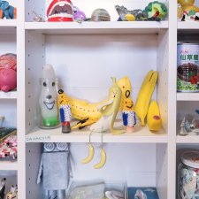 A collection of toys sitting on white shelves A collection of toys sitting on white shelves