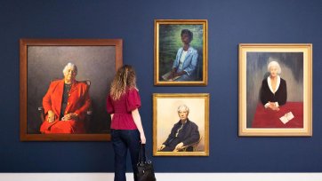 A person viewing artworks in Gallery Five