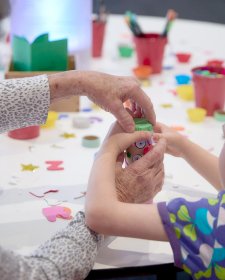 A child with crafting activities at a table