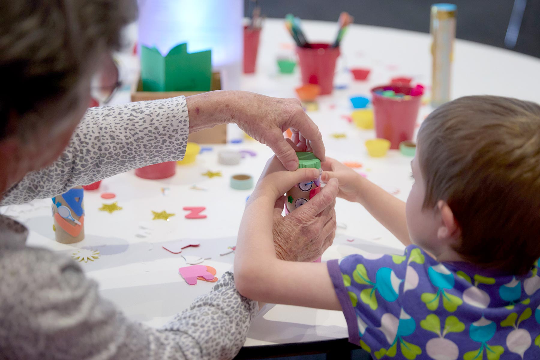 A child with crafting activities at a table