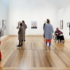 People viewing artworks in a gallery People viewing artworks in a gallery