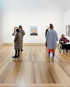 People viewing artworks in a gallery People viewing artworks in a gallery