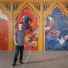 Ryan Presley in front of his artwork Paradise won