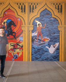 Ryan Presley in front of his artwork Paradise won