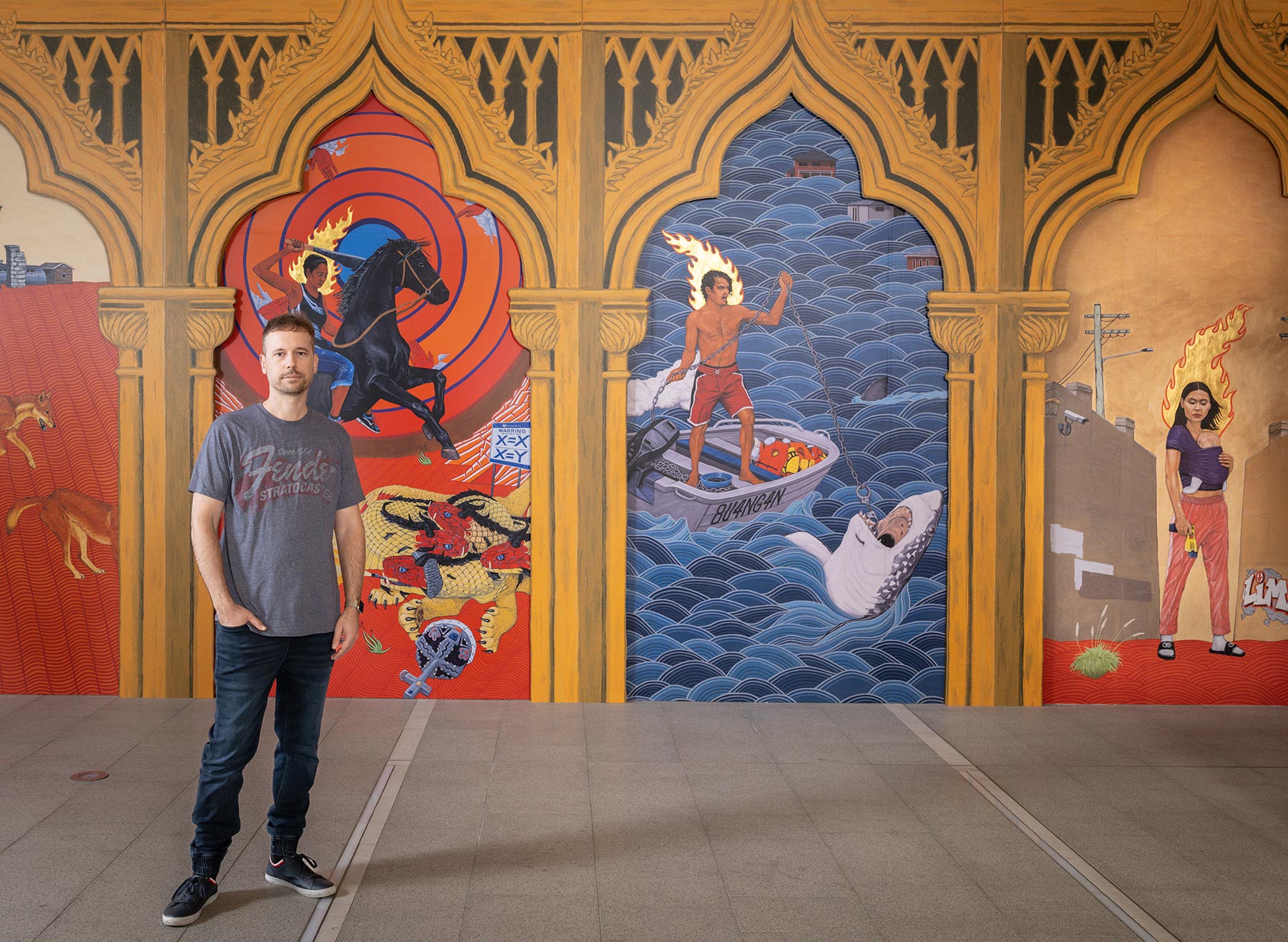 Ryan Presley in front of his artwork Paradise won