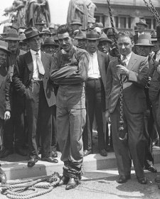 Murray frees himself from straightjacket in public, 1928 by Sam Hood