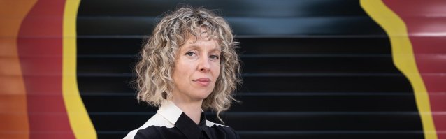 Bree Pickering standing in front of a colourful wall