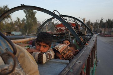 An Afghan refugee family drives into Nangarhar province after being evicted from their home in Pakistan. They had lived there since fleeing the Soviet–Afghan war of the 1980s, 2015 Andrew Quilty