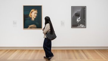 Visitor in the National Photographic Portrait Prize 2026 exhibition at the National Portrait Gallery, featuring works by finalists