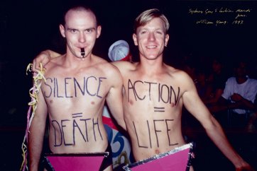 [Silence = Death, Action = Life written on the chests of two males, Sydney Gay & Lesbian Mardi Gras, 1993] William Yang