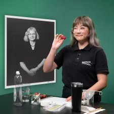A Questacon presenter holds a strawberry