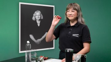 A Questacon presenter holds a strawberry