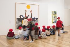 Children sitting in front of an artwork in Gallery Two