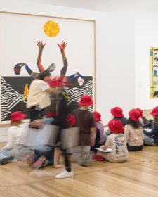 Children sitting in front of an artwork in Gallery Two