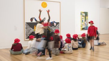 Children sitting in front of an artwork in Gallery Two