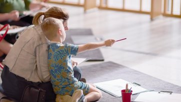 A mother and child drawing in Gordon Darling Hall
