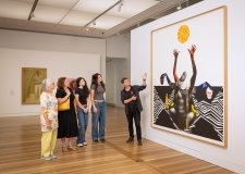 People looking at an artwork in the Gallery