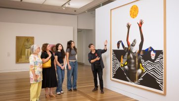 People looking at an artwork in the Gallery