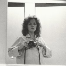 1/2 length self portrait in mirror, wearing pyjama shirt, camera at shoulder height, 1979 Carol Jerrems