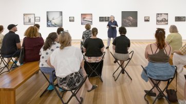 People listening to a talk in Gallery Five