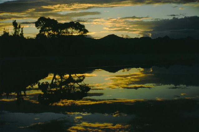 Sunset is reflected in the Lake Pedder waters as a storm approaches, Tasmania, 1971