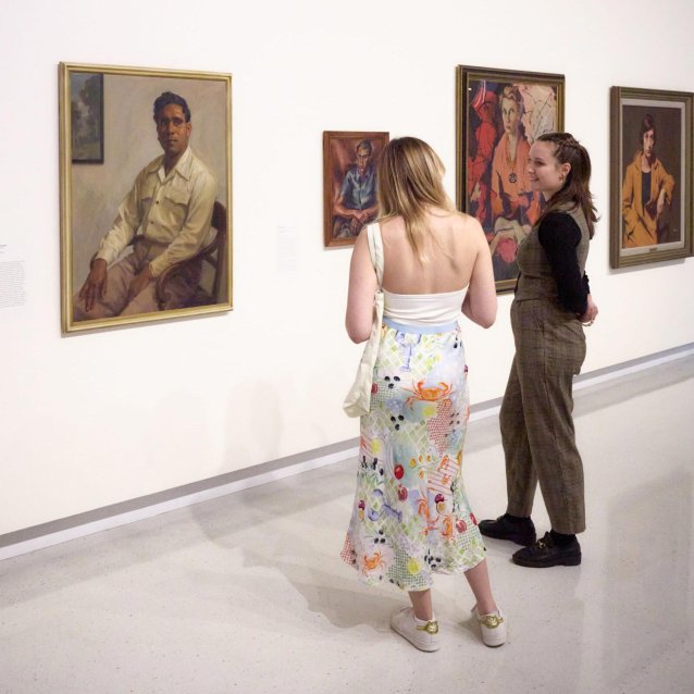 Visitors looking at Harold Blair, 1948 by Ernest Buckmaster. Purchased 2010 &copy; Estate of Ernest Buckmaster