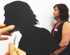 Cutting out a paper silhouette in the shape of a head Cutting out a paper silhouette in the shape of a head