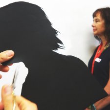Cutting out a paper silhouette in the shape of a head Cutting out a paper silhouette in the shape of a head