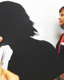 Cutting out a paper silhouette in the shape of a head Cutting out a paper silhouette in the shape of a head