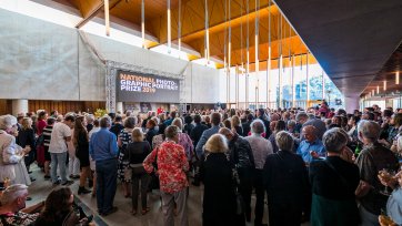 A large crowd of people in the Gordon Darling Hall for the National Photographic Portrait Prize launch in 2019