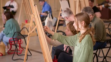 People drawing at easels in the Gordon Darling Hall