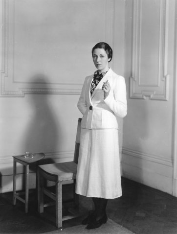 Amy Johnson wearing a woollen suit from the collection of flight clothes designed by Madame Schiaparelli for her solo flight from London to Cape Town, 1938 unknown photographer